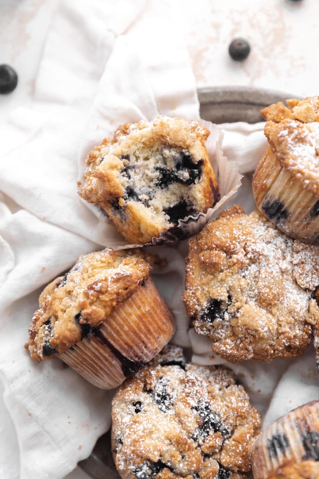 blueberry streusel muffins with a bite taken out