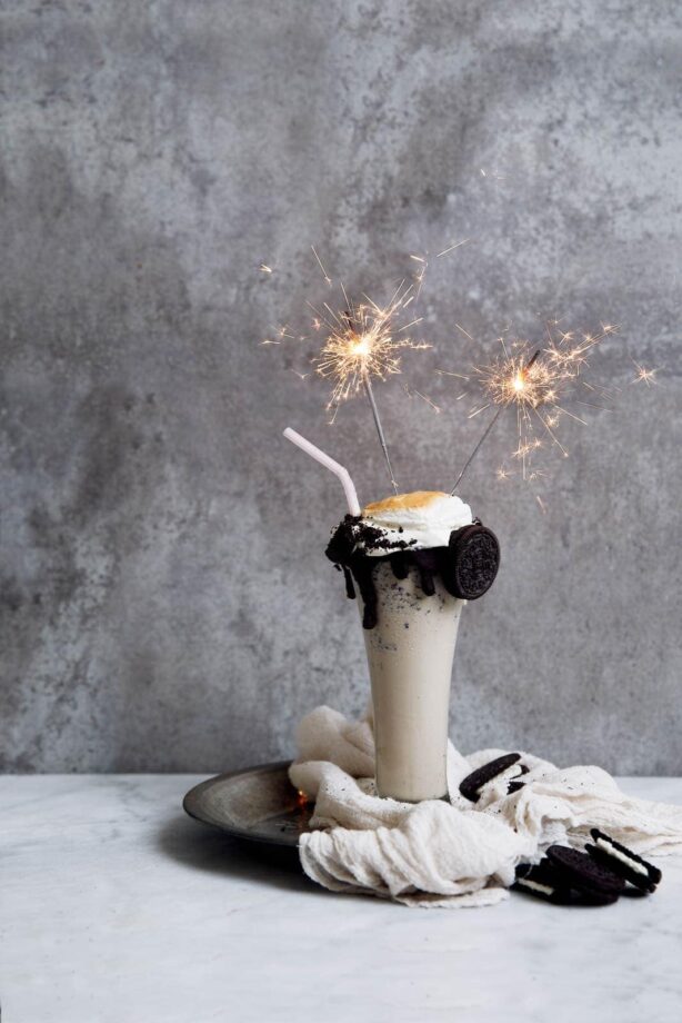 The ultimate Iced Coffee Cookies and Cream Milkshake, complete with chocolate sauce, whipped cream, and a giant toasted marshmallow